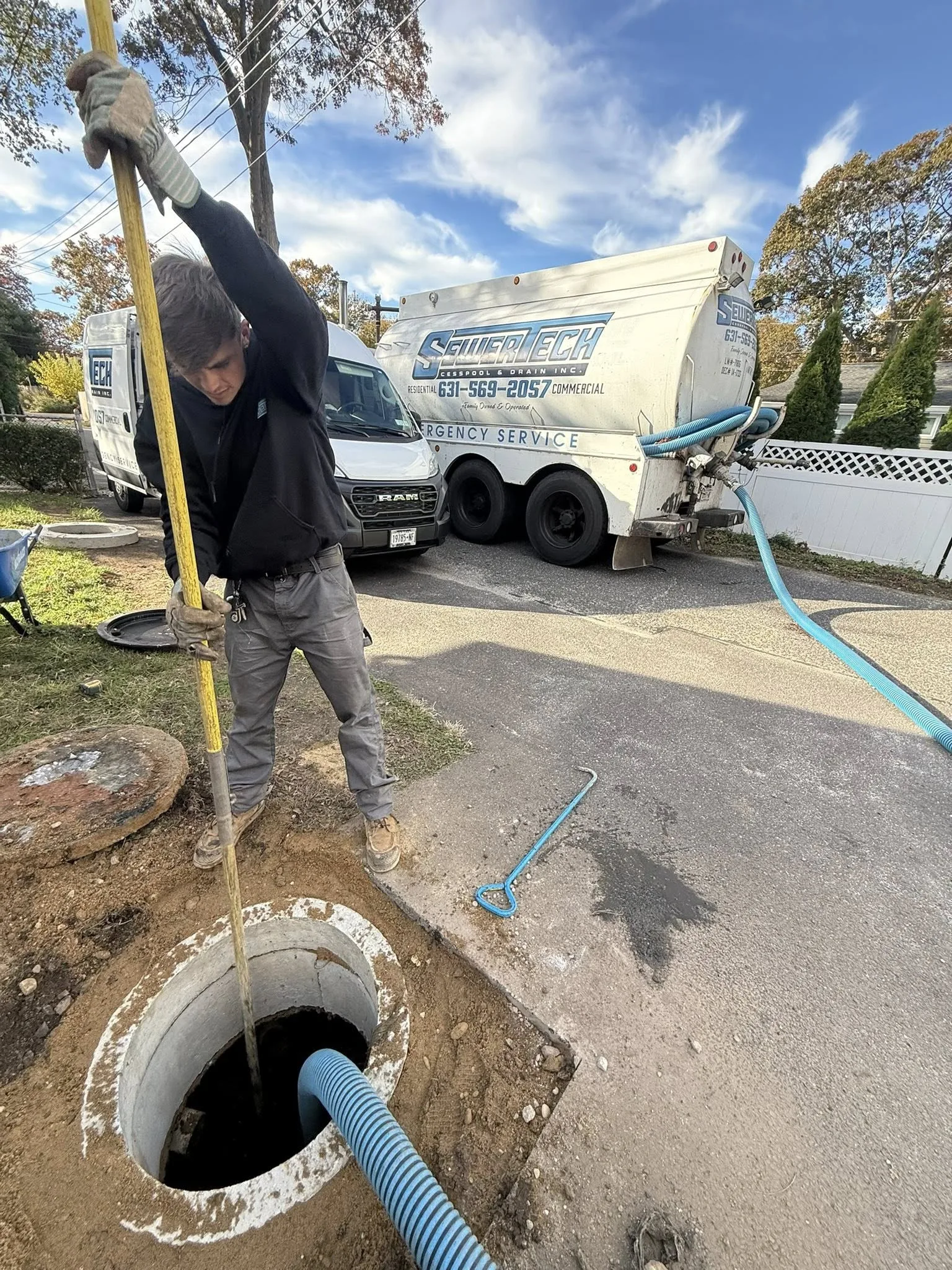 Professional septic pumping service truck clearing out a residential tank in Suffolk County NY.
