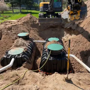 SewerTech LI heavy equipment excavating ground for a new septic system installation in Suffolk County NY.