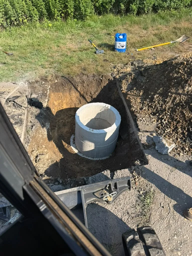 Professional technicians installing concrete riser rings on a cesspool tank in Suffolk County